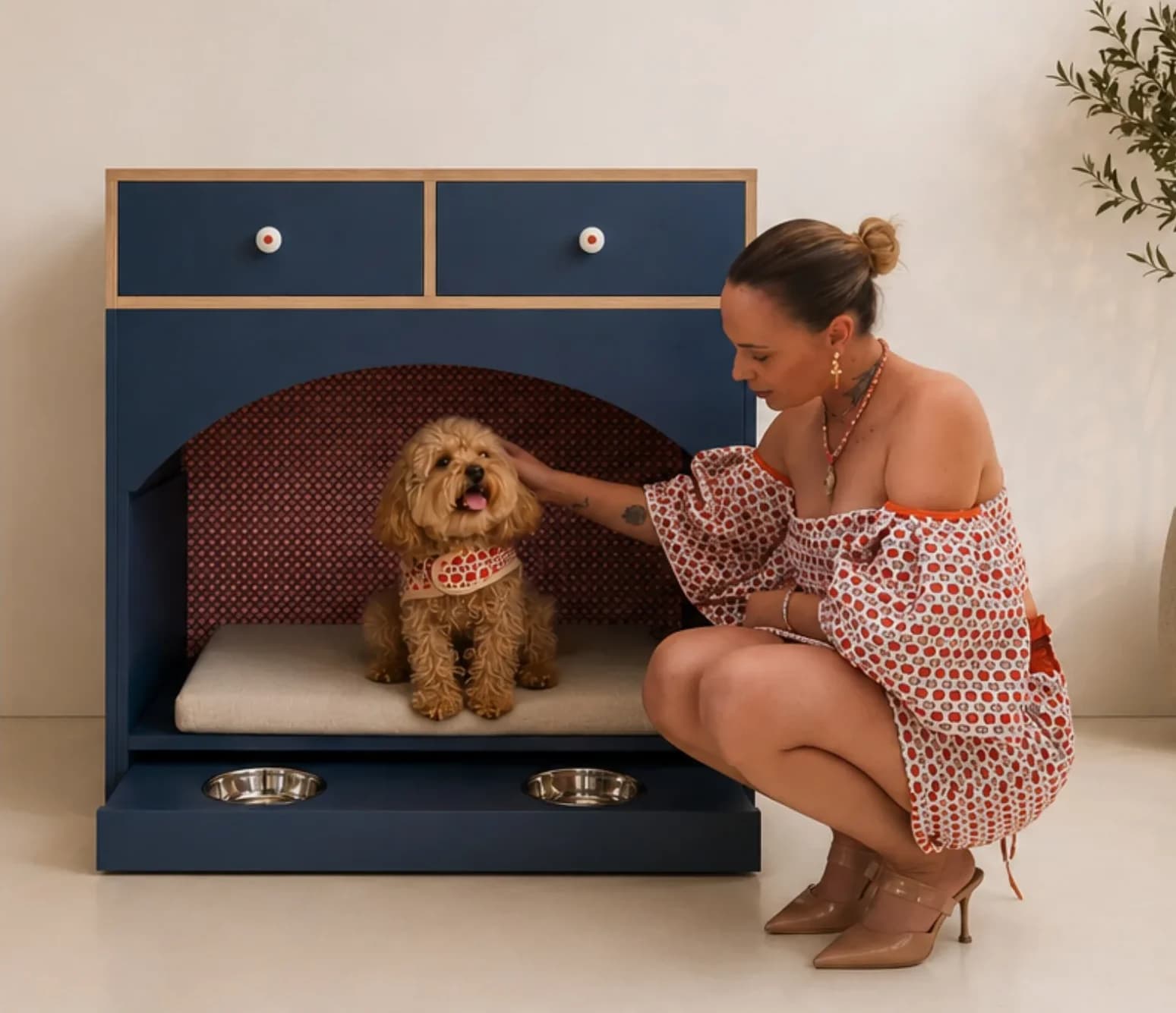 Navy Oddie with its owner, dressed in the geometric print of the alcove, stroking the dog; below, the tray with the two feeding bowls