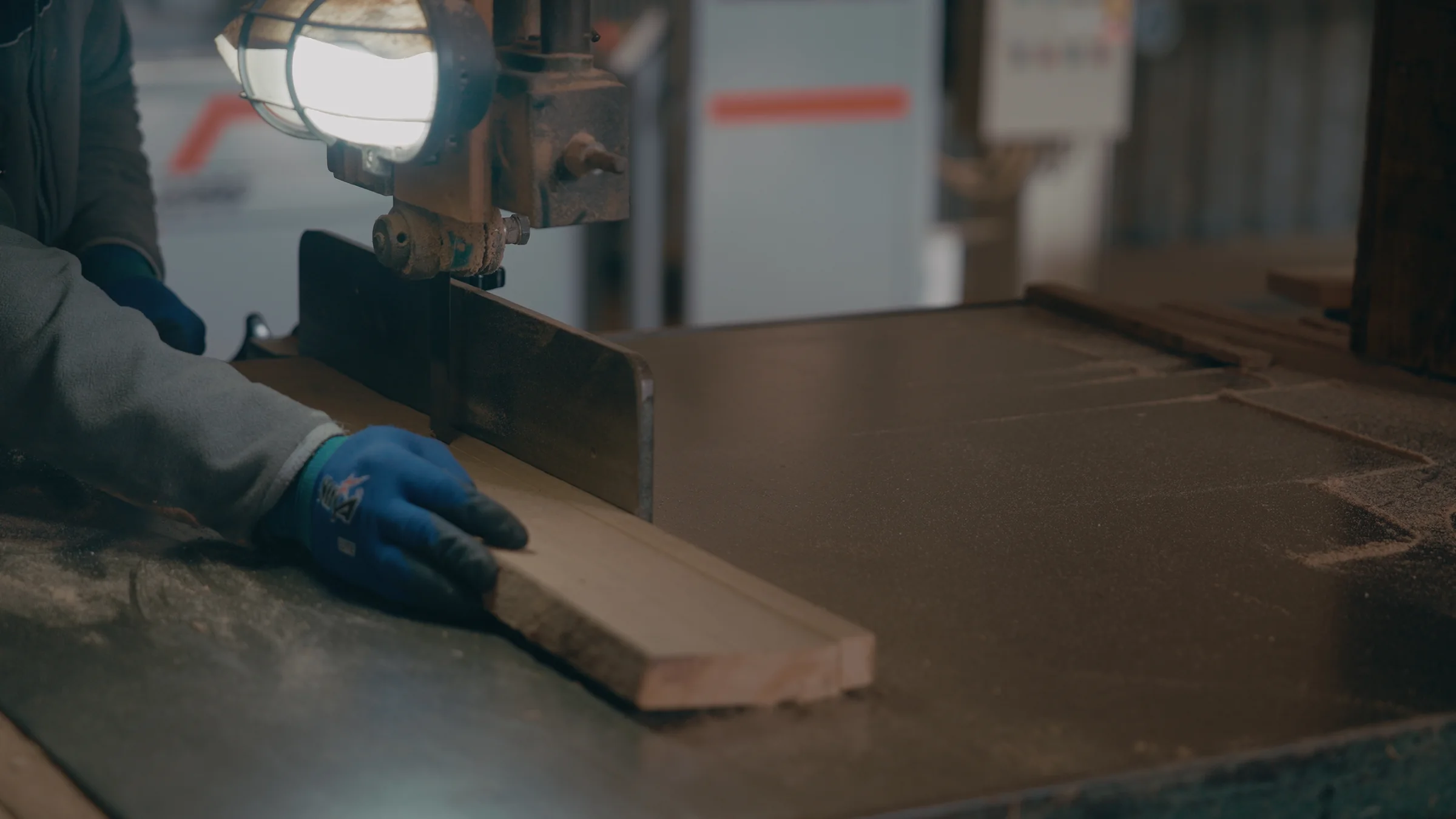 Cutting a piece of wood on the workshop saw